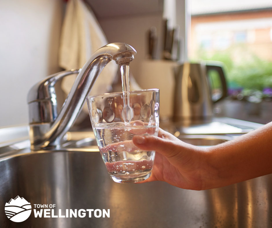 Image of water flowing into a cup from the sink 